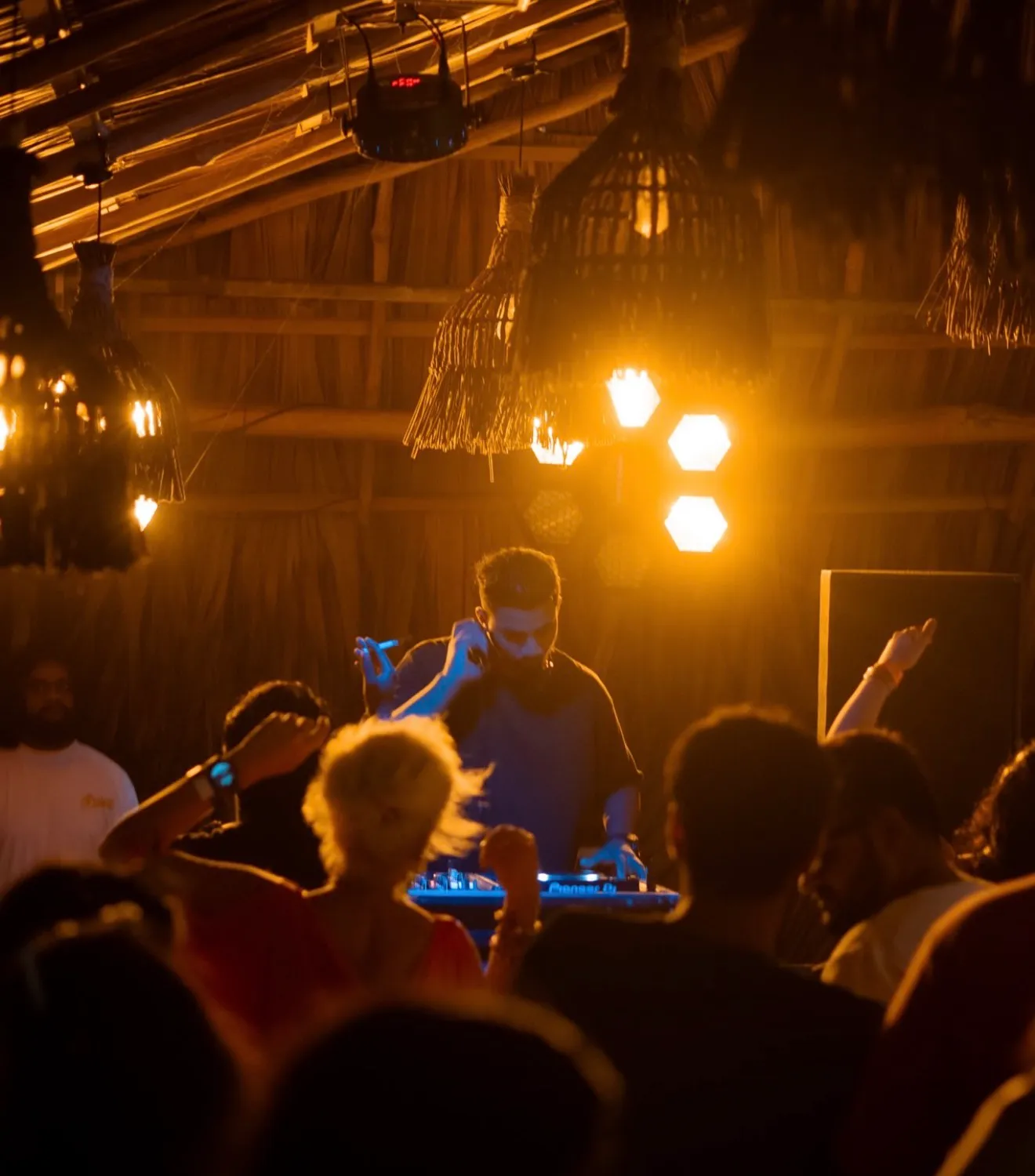 Crowd dancing under warm lights at a Hakuna Matata party night in Ahangama